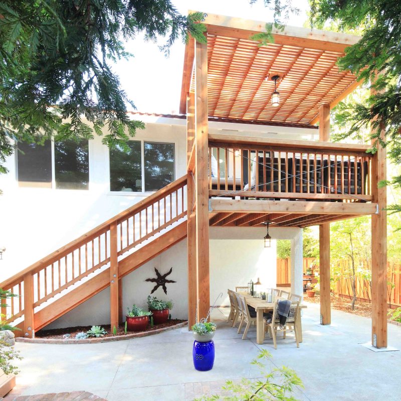 Interior designer and TV personality, Orlando Soria, renovated his parent's 1970's ranch house in Santa Rosa, California, adding a redwood deck and shade structure off the kitchen.